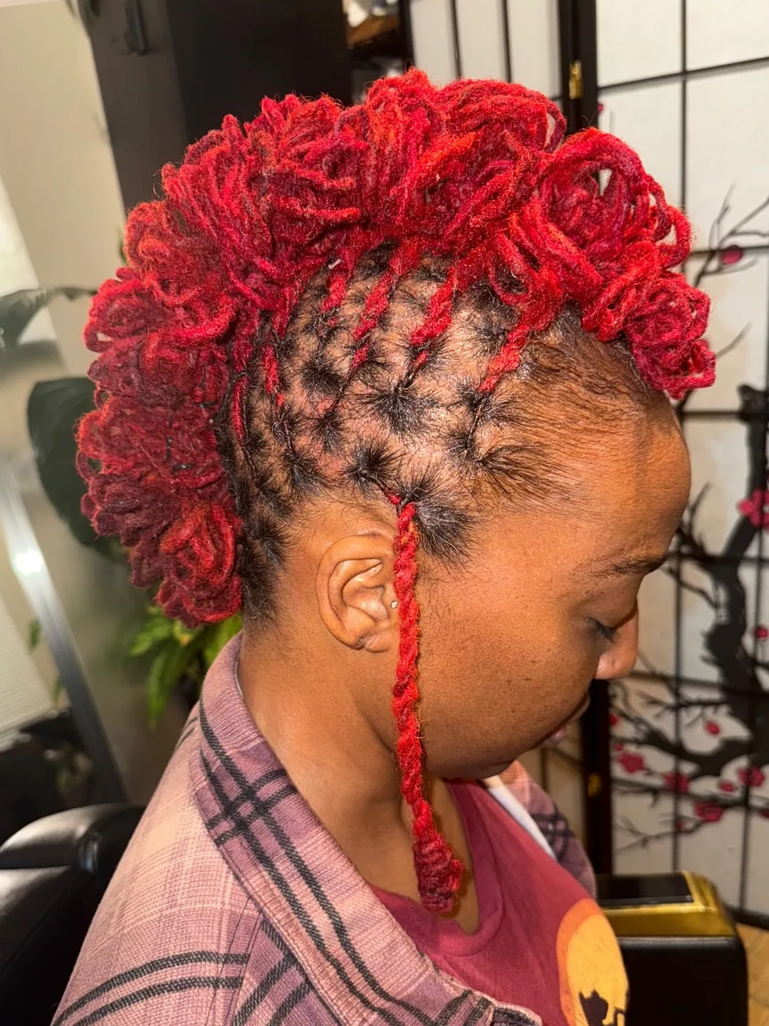 Loc updo styled in vivid red
